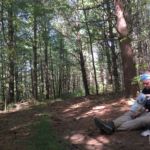 hiker taking break by trail