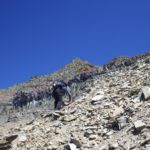 Ben scrambles up the loose talus on Mt. Merritt, Glacier National Park, MT
